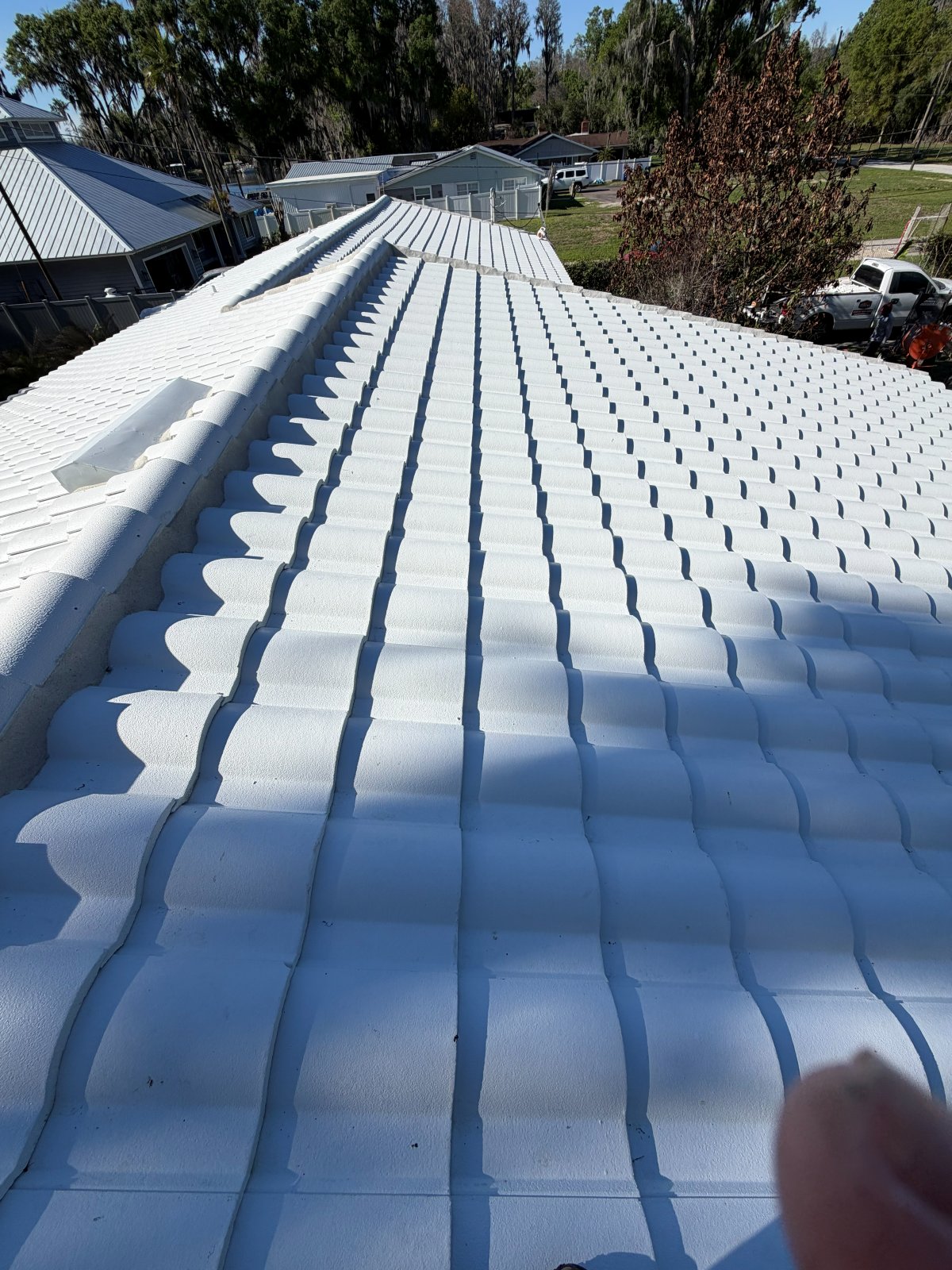 S-tile roof restoration on a Sarasota home — white concrete tile after coating