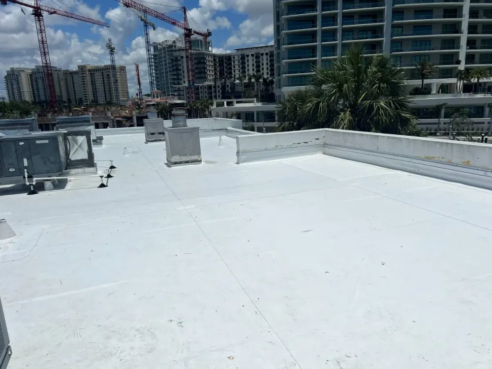 Completed white flat roof membrane with downtown Sarasota skyline in background