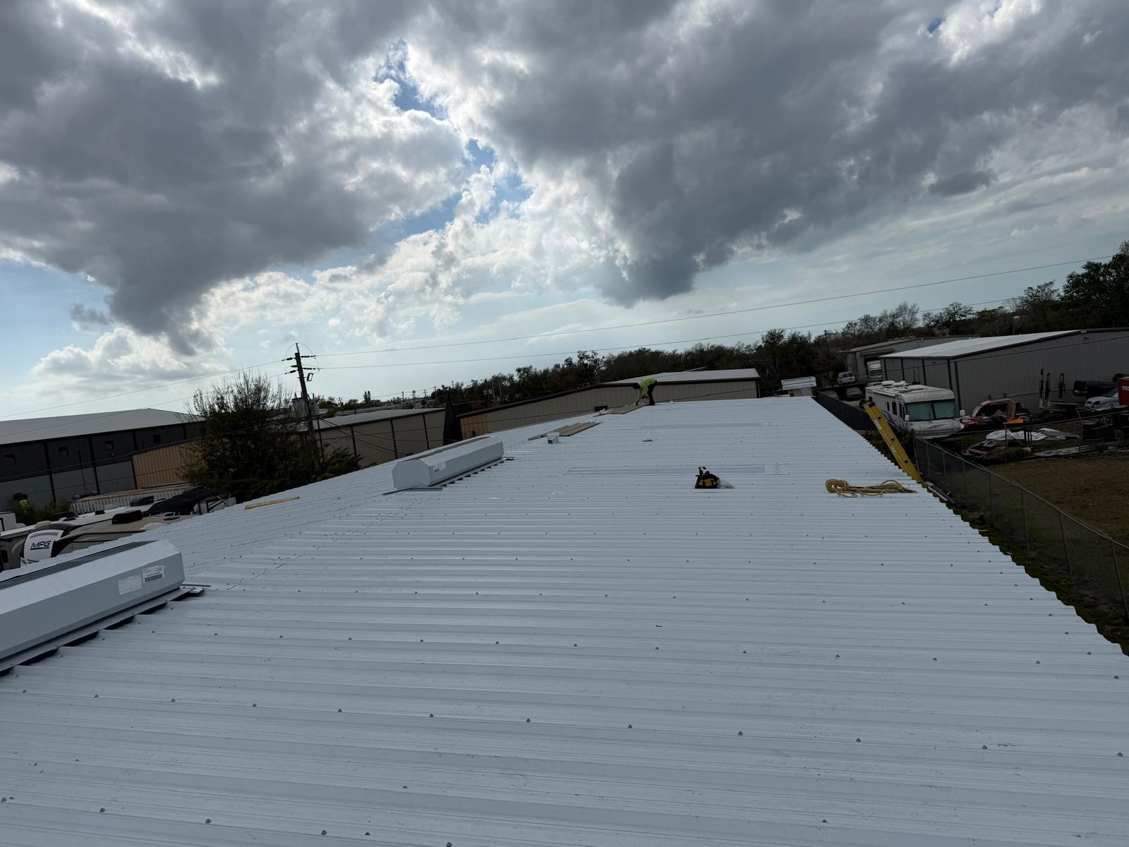 SRQ Building Services commercial roof project on a warehouse in Sarasota, FL