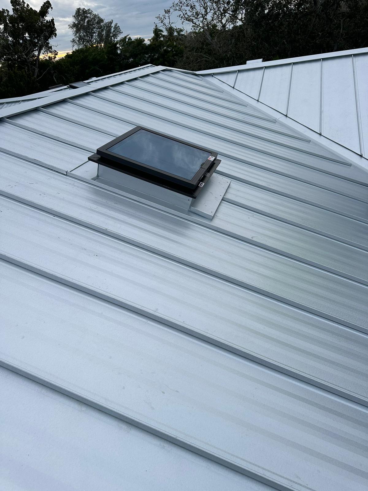 Metal roofing crew installing standing seam panels in Sarasota, FL