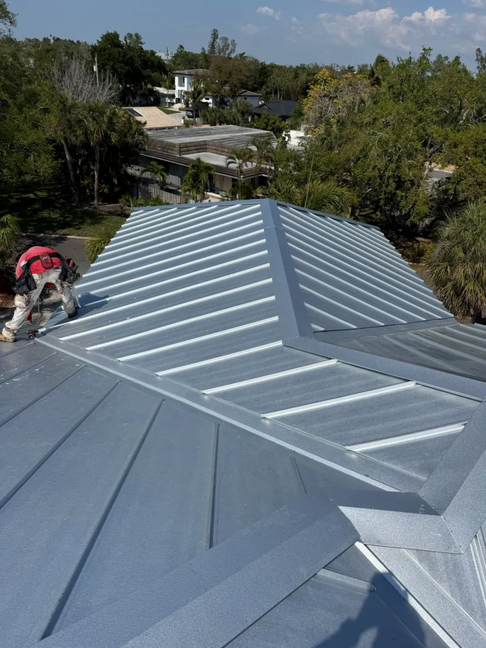 Completed standing seam metal roof with Florida neighborhood backdrop in Sarasota