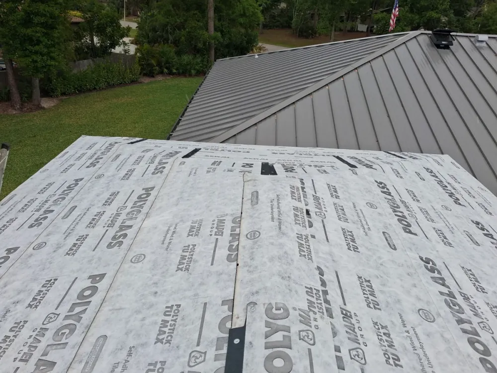 Metal roofing installation showing Polyglass underlayment and standing seam panels in Sarasota
