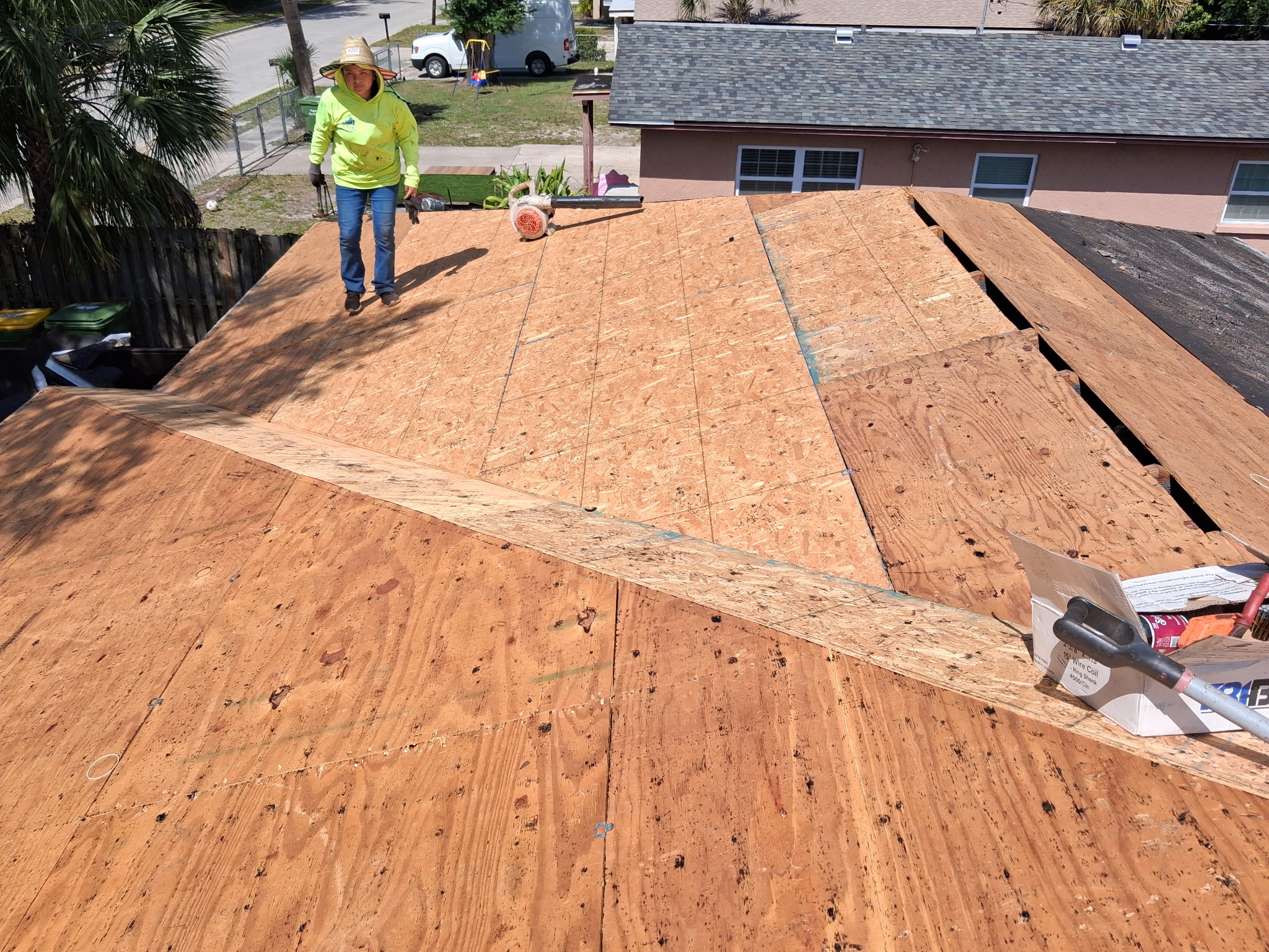 SRQ Building Services inspector performing a thorough roof inspection in Sarasota, FL