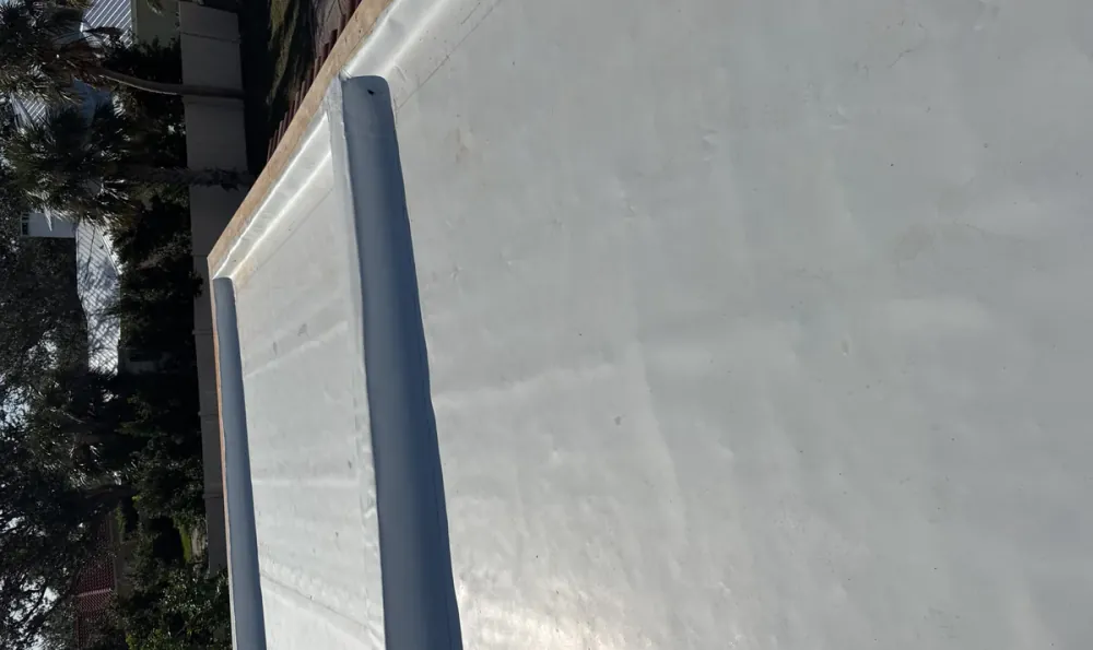 White TPO single-ply membrane with parapet wall on a residential addition in Sarasota